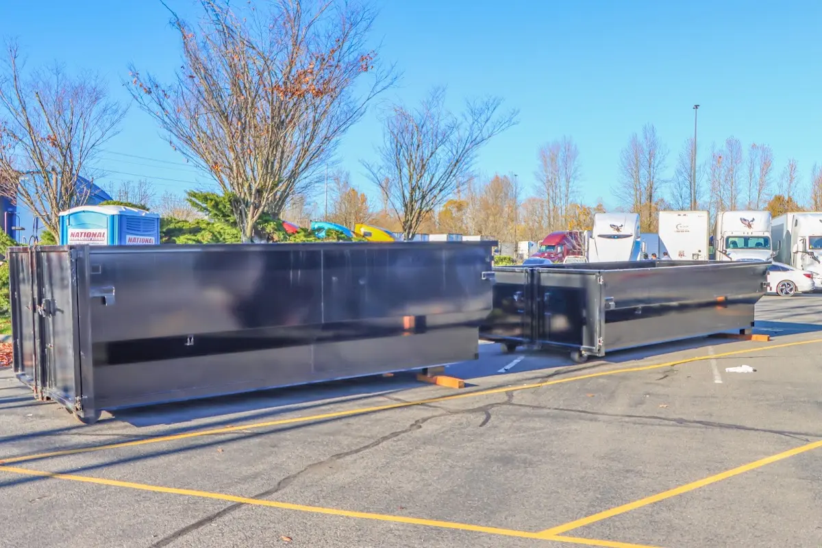 Professional dumpster rental service with roll-off container on residential driveway in Neshannock